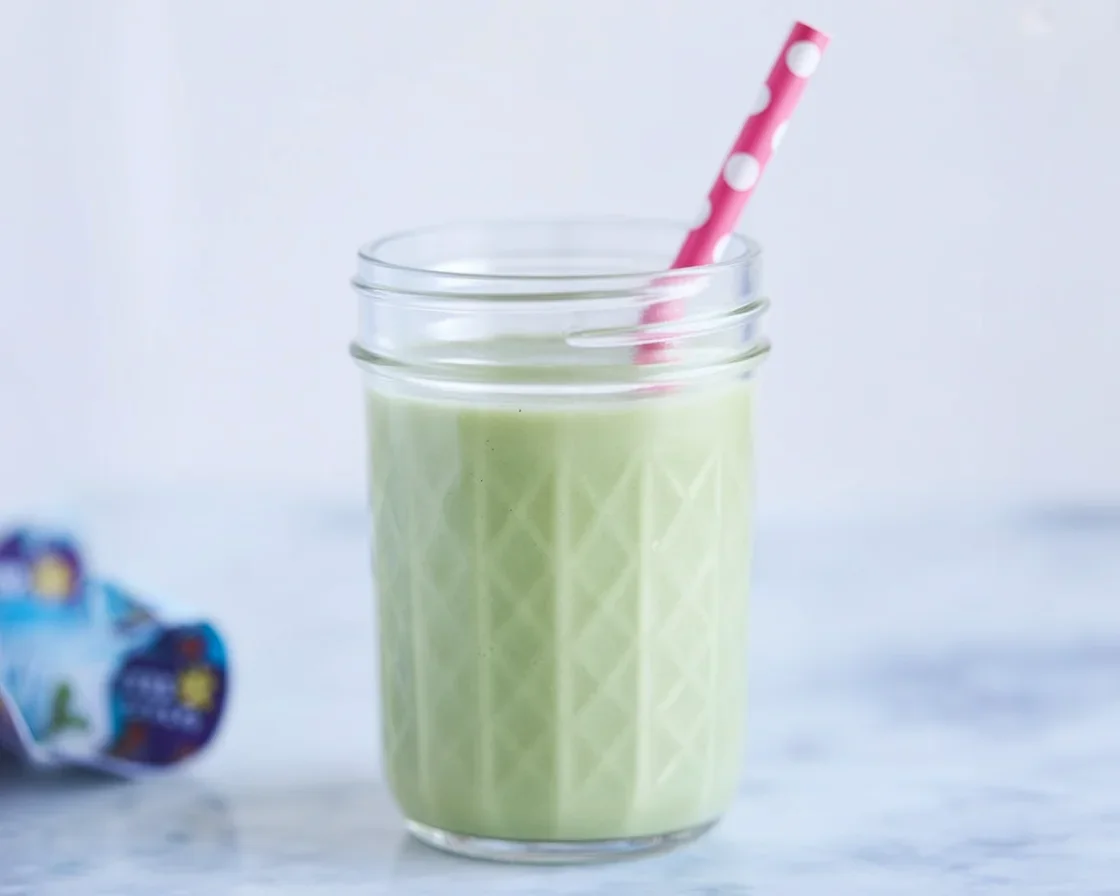 A vibrant green smoothie made from spinach, banana, and pineapple, perfect for kids.